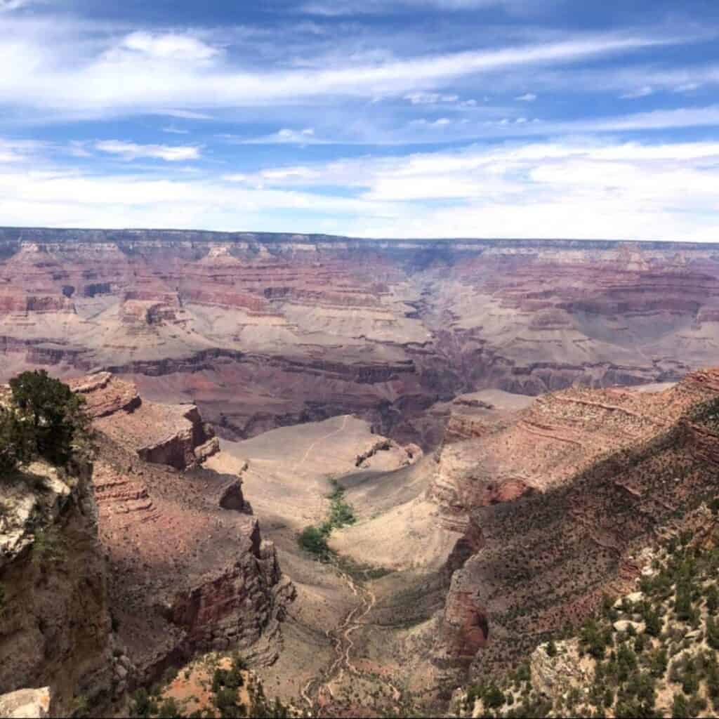 looking out over a valley of desert and red rock mountains