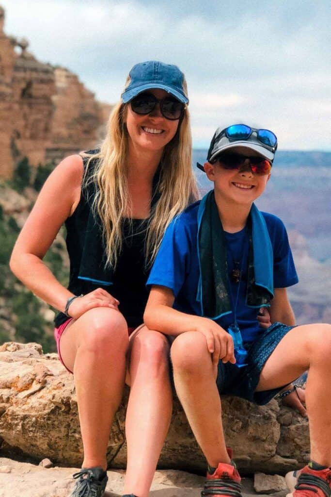 close up of mom and son wearing hats and sunglasses smiling on a hot sunny day
