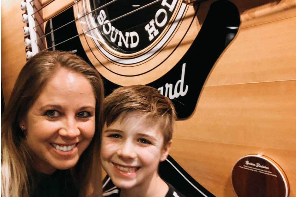 mom and son selfie in front of a huge guitar at the Country Hall of Fame