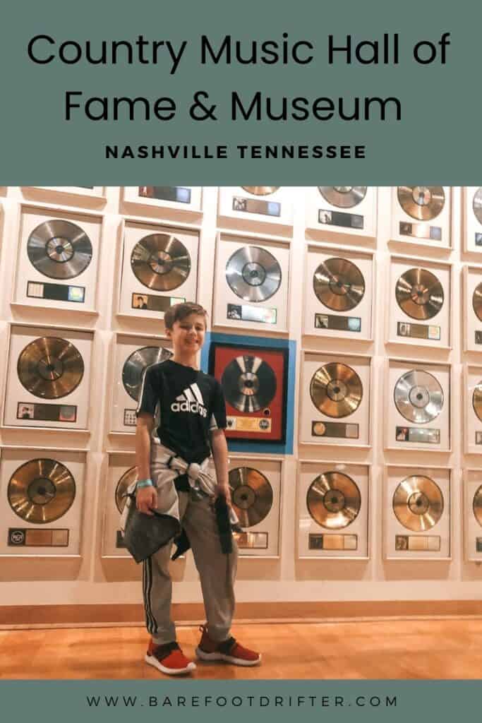Pin for pinterest with writing that says Country Music Hall of Fame and Museum Nashville Tennessee and a picture of a boy standing in front of gold and silver records wall