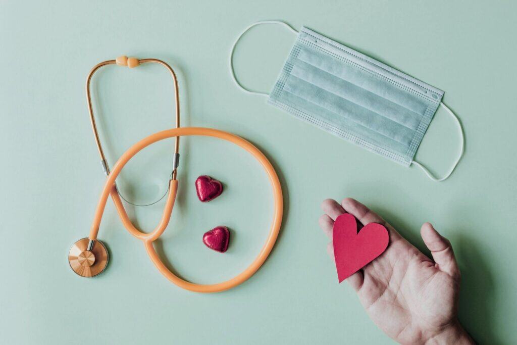 School nursing advocacy and compassionate care symbolized by stethoscope face mask and heart in hand
