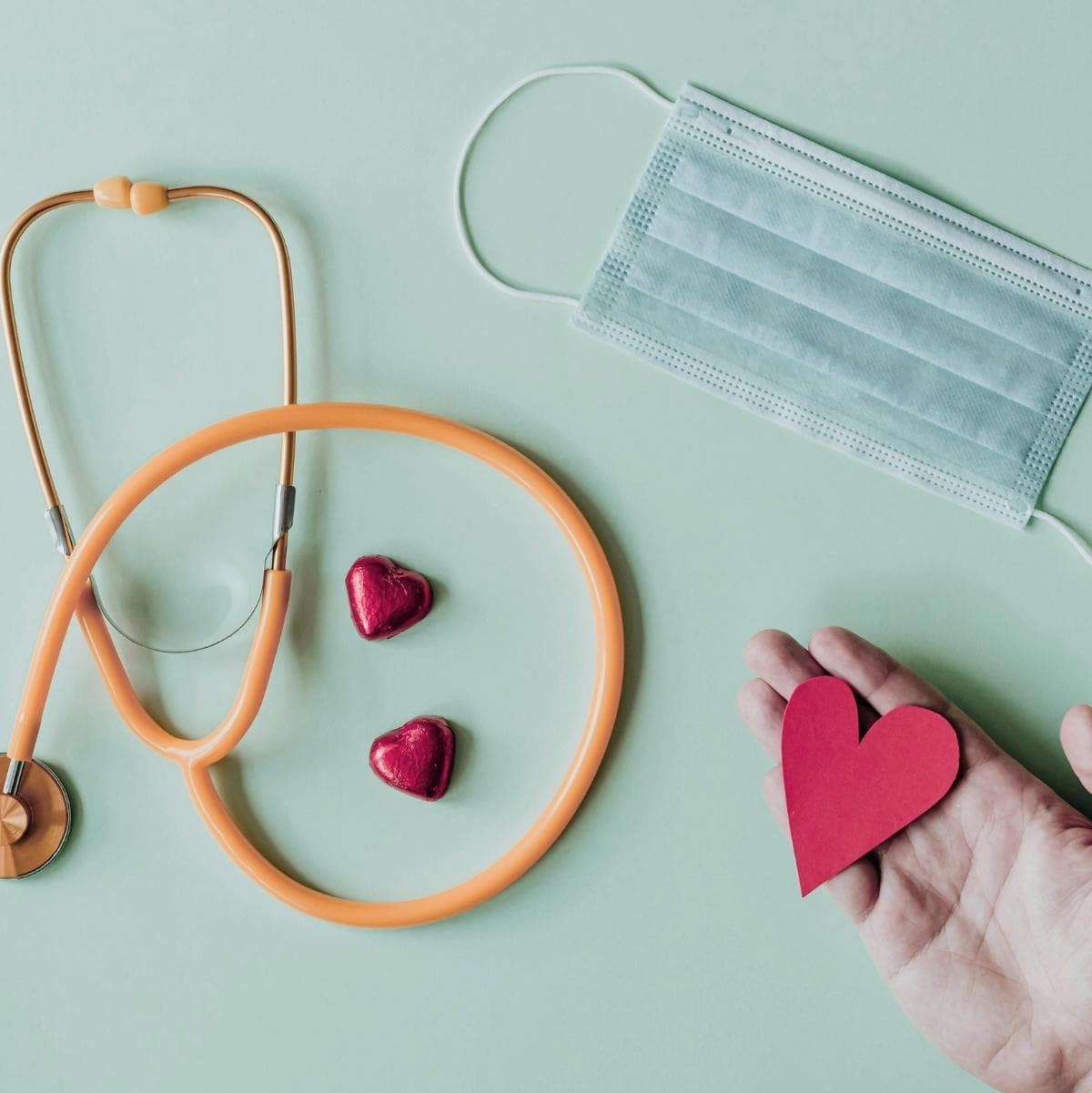 Live with Heart Lifestyle symbolized by stethoscope face mask and heart in hand