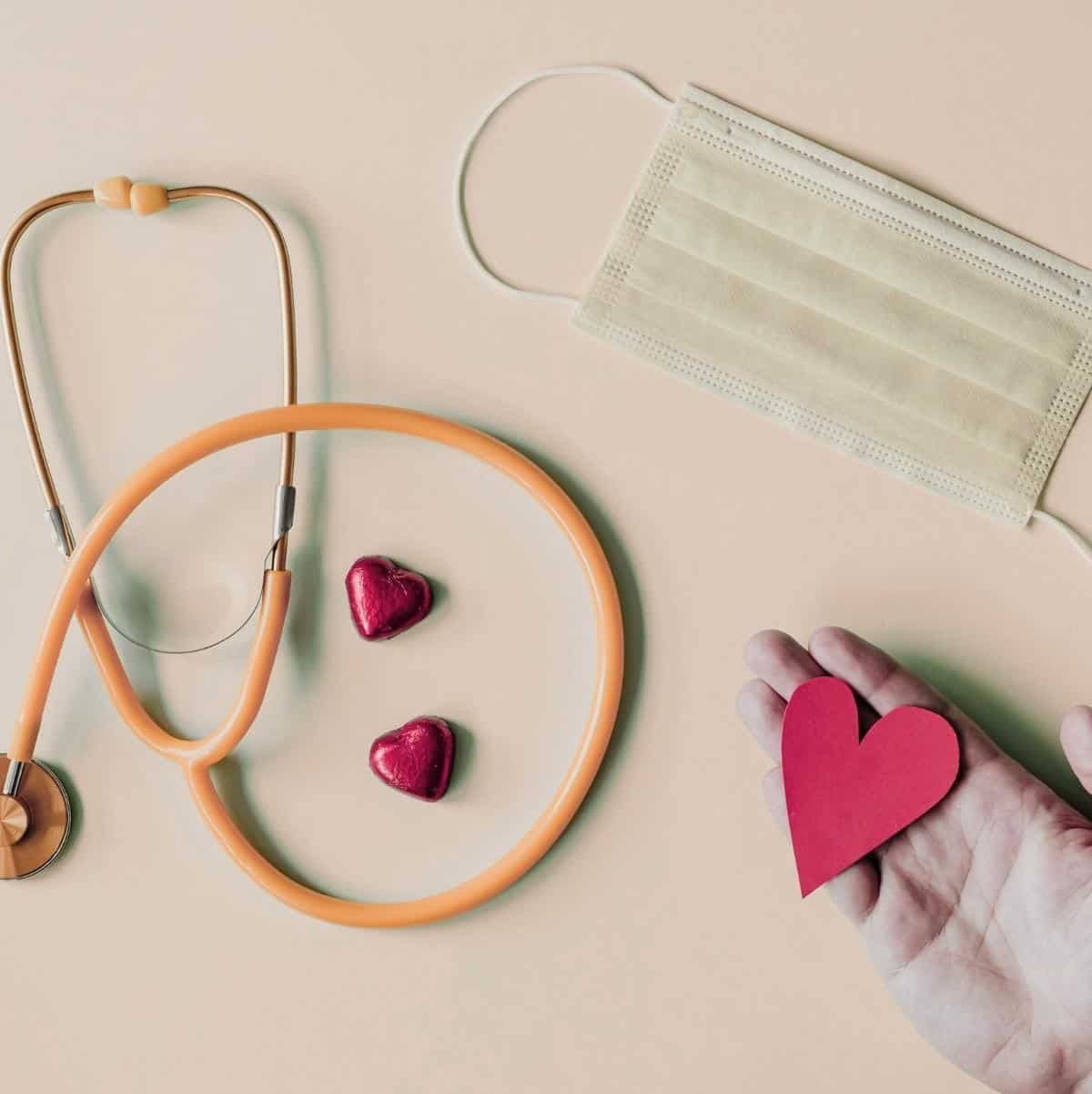 Live with Heart Lifestyle symbolized by stethoscope face mask and heart in hand