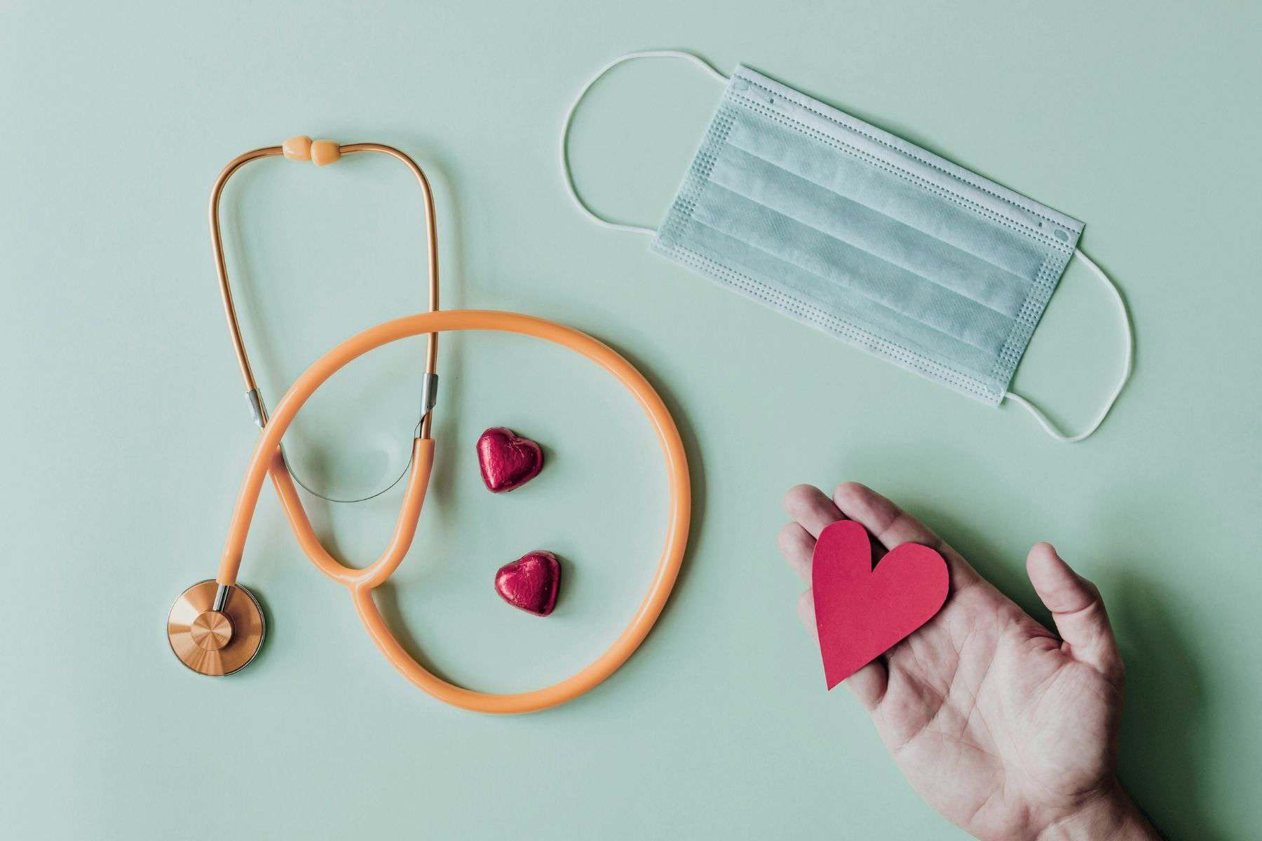 School nursing advocacy and compassionate care symbolized by stethoscope face mask and heart in hand