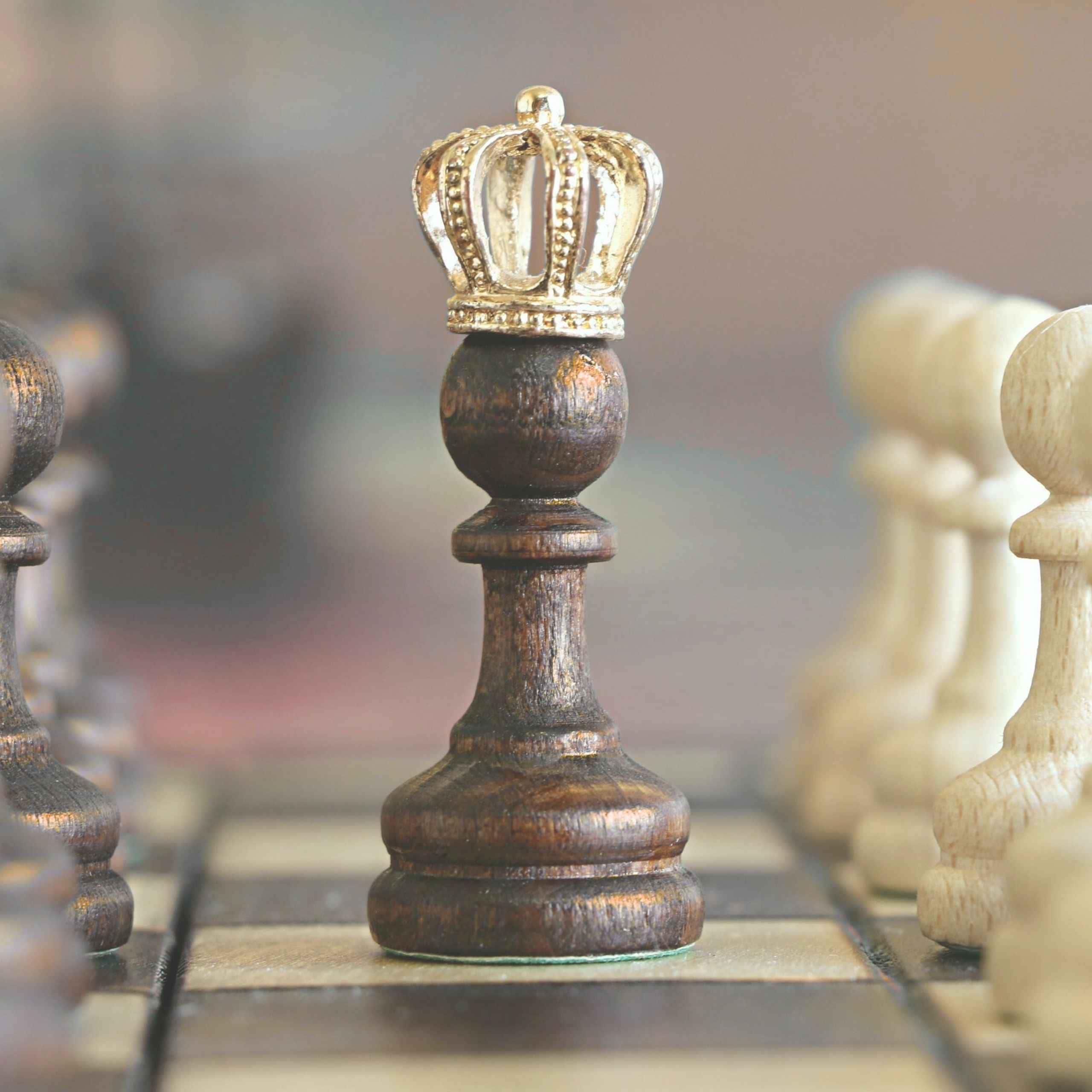 Wooden chess pawn wearing a crown symbolizing personal growth, self-worth, and transformation in everyday life