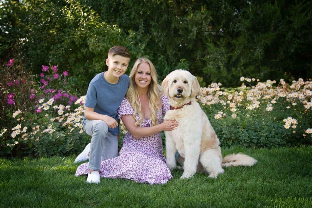 mother and son sitting with their dog in a peaceful garden representing emotional safety and stability for children