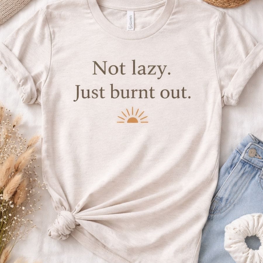 Wellness graphic t-shirt that says Not lazy. Just burnt out. with a minimalist sunrise design.
